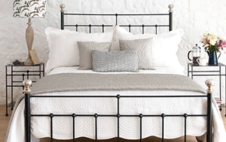 close up of black iron bed