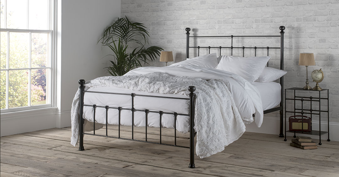 sophie iron bed powder coated in a texture black finish, dressed in white cotton bedlinen. Wth a tall headboard and geometric features the sophie iron bed offers timless design. 