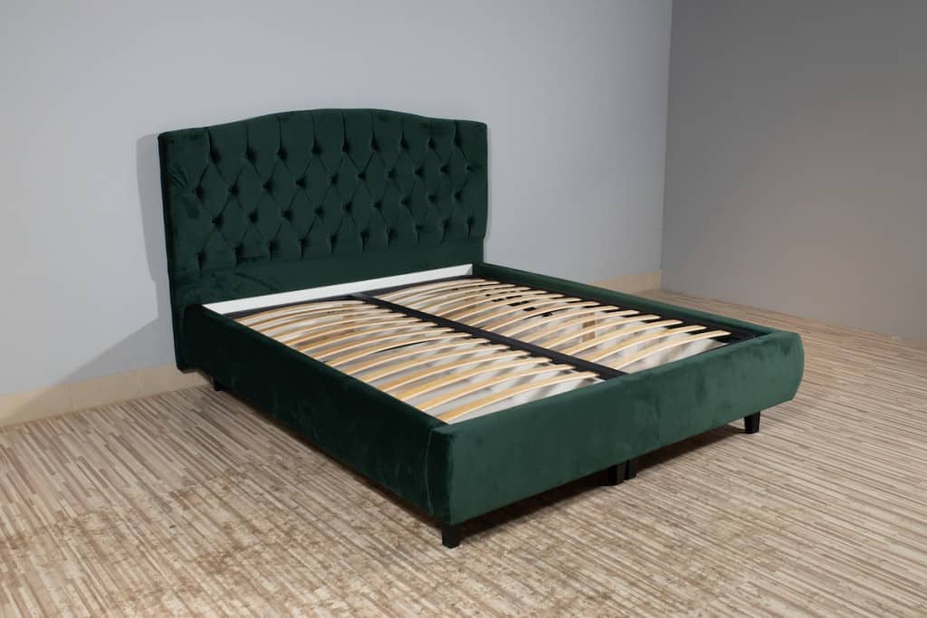 Upholstered bed with a slatted base
