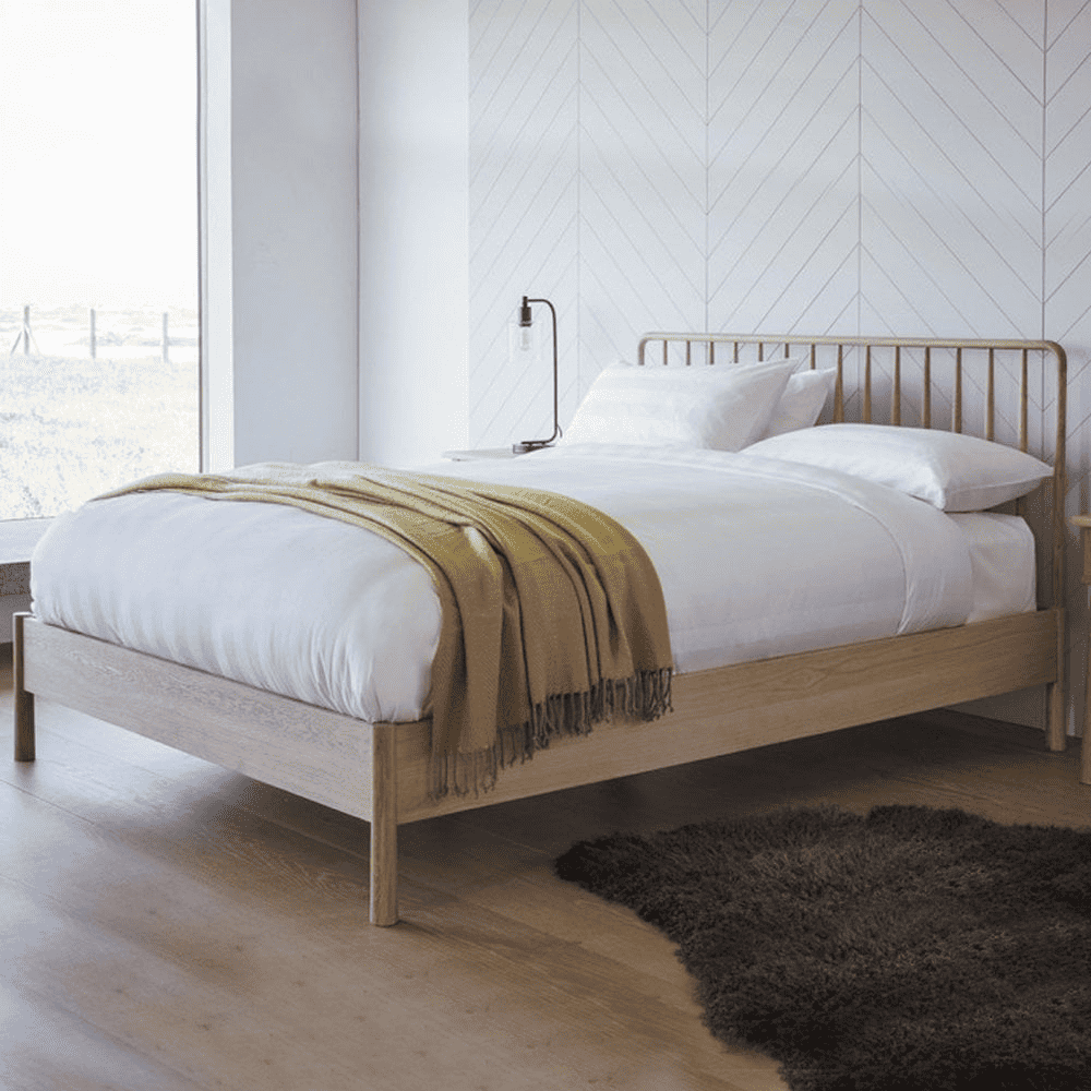 Modern spindle bed in a white room