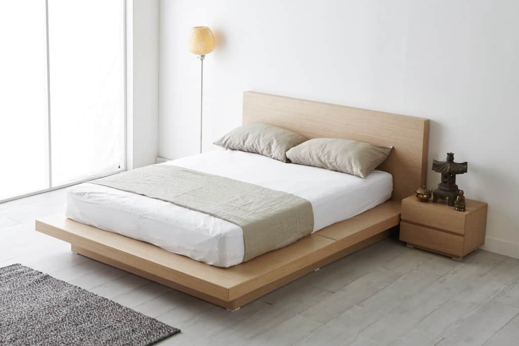 Simple wooden platform bed in a light wood