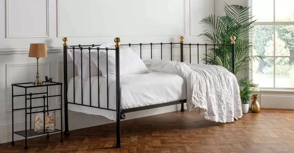 Iron daybed against a wall