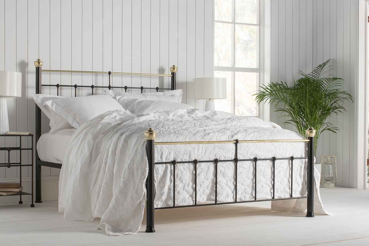 Bertie iron bed with black and brass finish, styled with white bedding in a bright traditional bedroom