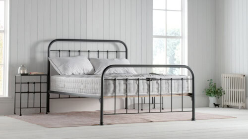 natural fibre mattress on dark grey dormatory style iron bedframe, in a white / coastal inspired bedroom.