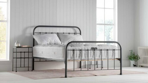 natural fibre pocket sprung mattress layered with wool, cotton and cashmere on an iron bedframe in a white nautical inspired bedroom with two georgian windows
