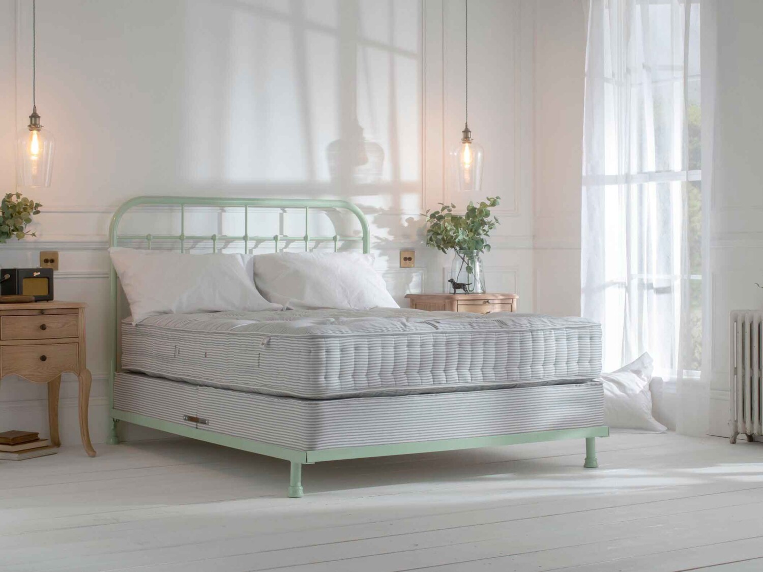 Light green in bright airy bedroom with large windows