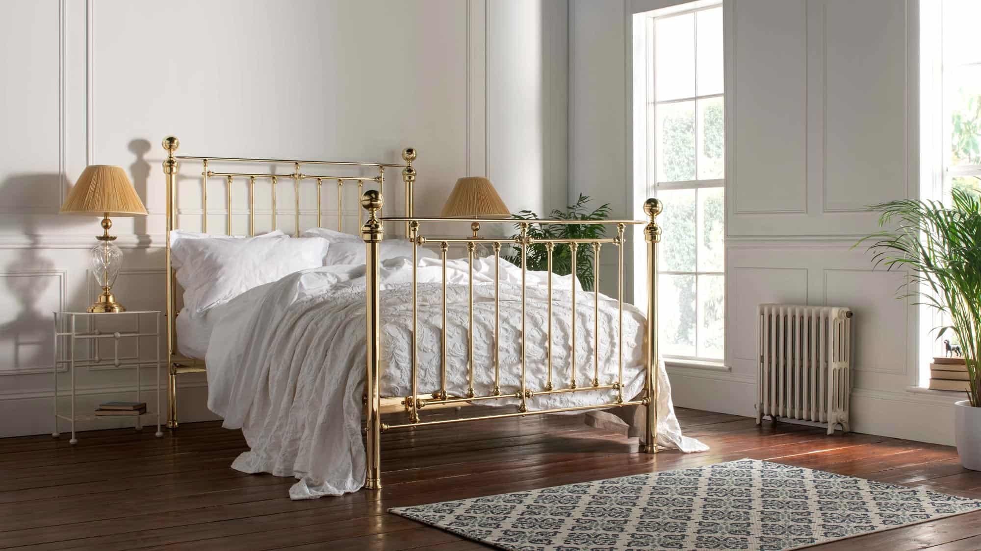 Full view of the Willow brass bed in a classic bedroom setting