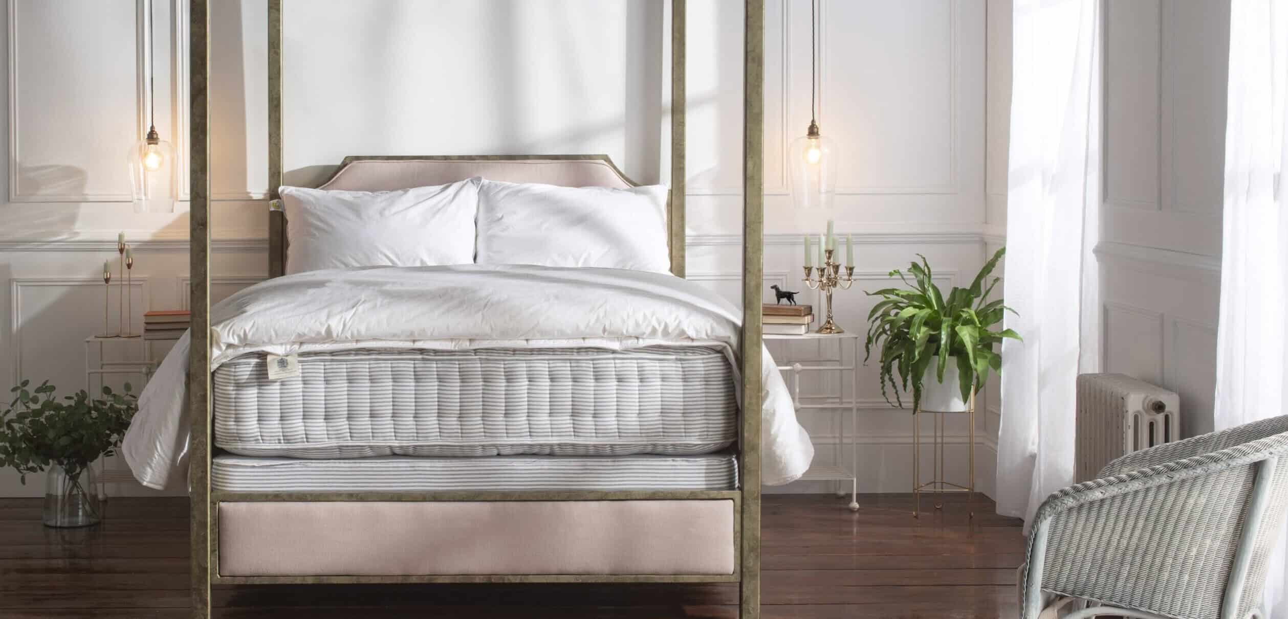 Bed base and mattress in butcher's stripe on Aurora iron bed with white bedding